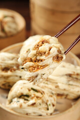Steamed Meat Buns with Chopsticks Showing Filling - Traditional Asian Dumplings on Bamboo Steamer