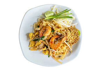 Traditional Thai stir-fried noodles with prawns, tofu, egg, bean sprouts, and crushed peanuts, served with lime and chives on a white plate.