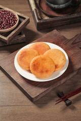 Handmade Golden Fried Bean Cakes Traditional Asian Snack Food on Rustic Wooden Table with Chopsticks