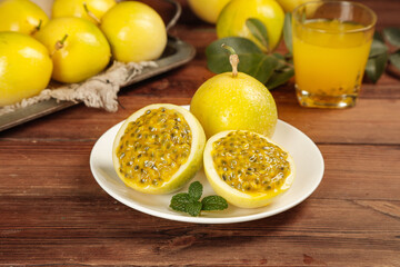 Golden Passion Fruit Halves with Seeds and Juice Display on Wooden Table