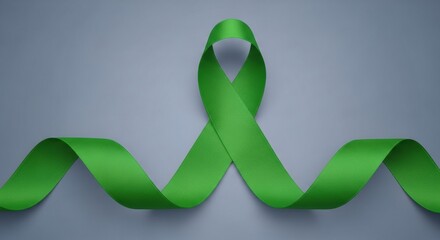 A long, flowing green awareness ribbon for mental health, liver, or environmental causes, waving on a simple grey background.