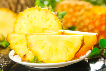 Fresh Pineapple Slices with Sweet Crisp Flesh and Mint on White Plate