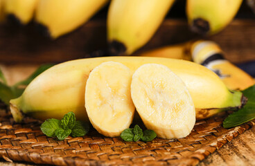 Fresh Hainan Emperor Bananas Sliced on Wooden Board with Mint Leaves - Sweet Fragrant Tropical Fruit