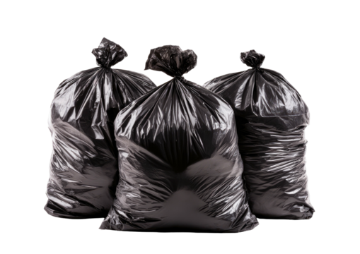 Three filled black plastic garbage bags against a black backdrop