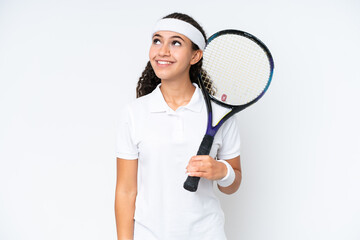 Young tennis player woman isolated on white background thinking an idea while looking up