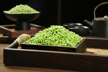 Fresh Green Mung Beans in Traditional Wooden Measuring Box with Tea Set Background