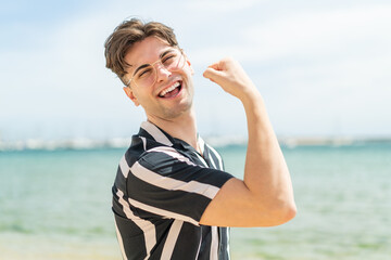 Young handsome man With glasses and celebrating a victory
