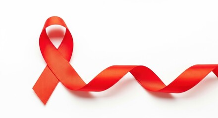An elegant red awareness ribbon for HIV/AIDS, with a long, flowing tail, isolated on a pure white background.
