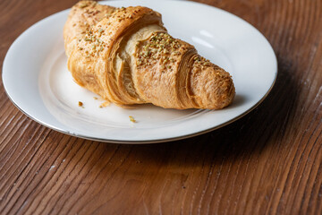 Close-Up of Pistachio and Cream Croissant on a Plate
