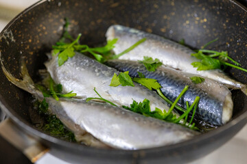 Close-Up of Fish Cooked with Parsley in a Pan
