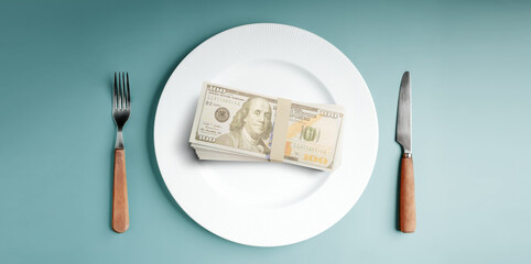 Money served on a plate with cutlery symbolizes capitalism. Table Top View