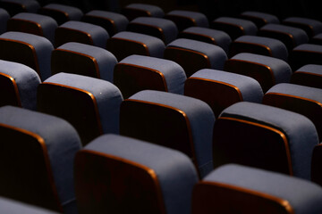 Fototapeta premium Karachi, Pakistan - April 10, 2025: A captivating view of multiple rows of empty seats under dim lighting, Ideal for concepts related to education, presentations, cinema, events, or public gatherings.