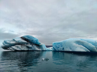 Fototapeta premium Textured Foreground Ice with Layered Glacier and Volcanic Ash in Iceland’s Highlands