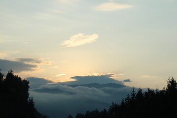 Sunrise in a cloudy sky. Morning in the mountains.