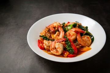 Stir fried spicy shrimp in a white plate