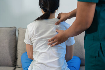 Obraz premium Help of a therapist trainer during a rehabilitation session. woman doing exercise at clinic with physiotherapist.
