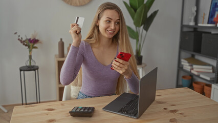 Young woman in living room calculating expenses with smartphone laptop and calculator, surrounded by cozy home decor and vibrant plants in a relaxed apartment setting.