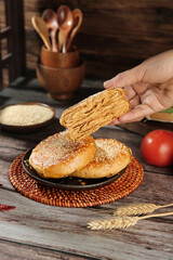 Traditional Chinese Sesame Seed Pastry Cake Being Prepared in Rustic Kitchen Setting