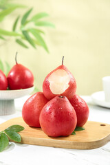 Fresh Red Pears from Shaanxi China on Wooden Board - Premium Imported Fruit with Peeled Sample