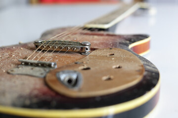 Musical instrument - Closeup fragment old, dirty, broken guitar. Bridge