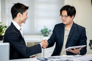Two businessmen are discussing plans in the office.