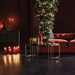 Vertical Christmas scene with creative upside-down tree and candles. Elegant festive interior with red sofa and gold ornaments.