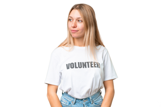 Young volunteer woman over isolated chroma key background looking to the side