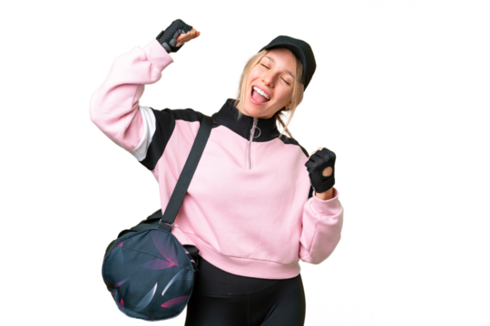 Pretty sport woman with sport bag over isolated chroma key background celebrating a victory