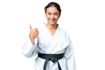 Young Uruguayan woman over isolated chroma key background with thumbs up because something good has happened