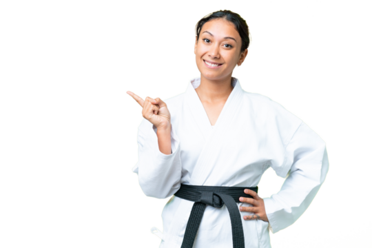 Young Uruguayan woman doing karate over isolated chroma key background pointing finger to the side - Powered by Adobe