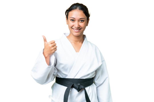 Young Uruguayan woman over isolated chroma key background with thumbs up because something good has happened