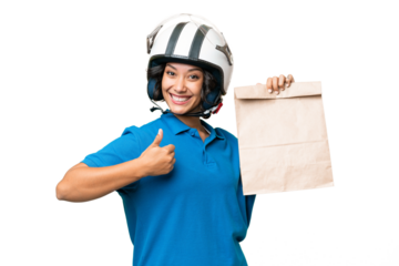 Young Argentinian woman taking a bag of takeaway food over isolated background with thumbs up because something good has happened