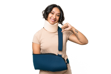 Young argentinian woman wearing neck brace and sling over isolated background proud and self-satisfied