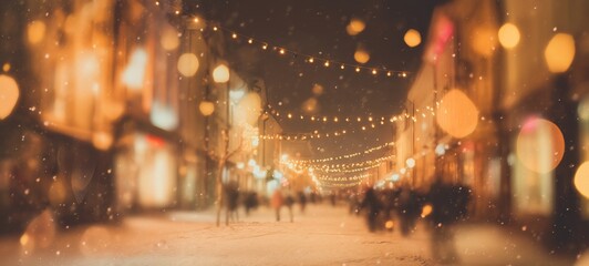 Obraz premium Festive Christmas city street at night with falling snow, glowing holiday lights, decorated shop windows, people in winter clothing, bokeh background, wide shot with copy space for design or marketing