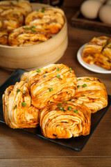Spicy Korean Kimchi Pancake Rolls with Green Onions on Wooden Table