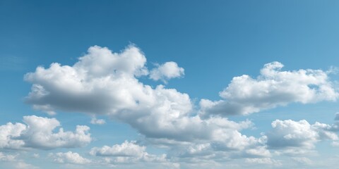 Obraz premium White fluffy cumulus clouds scattered across a clear blue sky with a gentle atmosphere