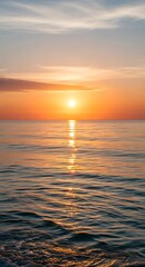 Fototapeta premium Golden Sunset Over the Calm Ocean Waters Reflecting Sunlight.