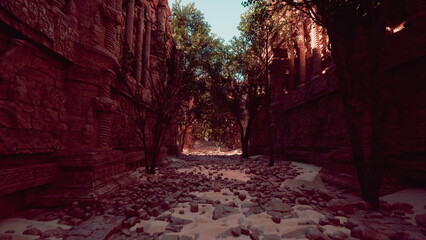Tall stone structures rise amid lush greenery, creating a peaceful atmosphere in a historic canyon. Sunlight filters through the trees, casting soft shadows on the rocky path ahead.