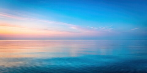 Obraz premium Soft focus misty sea horizon with subtle gradient colors and pastel blue hues at dusk