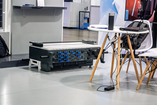 Advanced industrial control panel with blue switches and knobs in a modern tech environment. Ideal for themes of engineering, electronics, and innovation at trade shows or labs. - Powered by Adobe