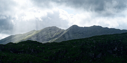 Dramatic mountain landscape with a cloudy sky. Creates a sense of awe and wonder.
