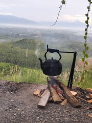 The kettle image shows boiling water and smoke rising from the wood.