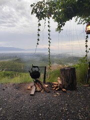 The kettle image shows boiling water and smoke rising from the wood.