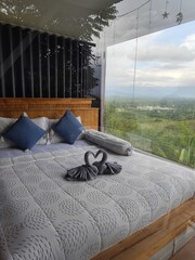 Place the bed against the glass wall to provide a view.