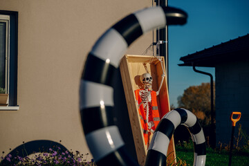 Halloween background. Halloween skeleton for decorated house. Scary decorated front yard of American house. Caricature or something. Halloween background. Autumn holiday of Halloween.