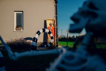 Halloween background. Halloween skeleton for decorated house. Scary decorated front yard of American house. Caricature or something. Halloween background. Autumn holiday of Halloween.