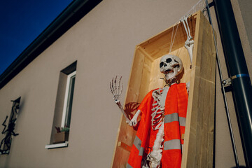 Halloween background. Halloween skeleton for decorated house. Scary decorated front yard of American house. Caricature or something. Halloween background. Autumn holiday of Halloween.