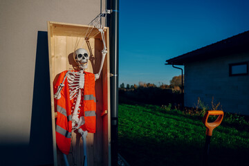 Halloween background. Halloween skeleton for decorated house. Scary decorated front yard of American house. Caricature or something. Halloween background. Autumn holiday of Halloween.