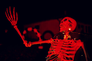 Night Halloween background. Halloween skeleton for decorated house. Scary decorated front yard of...