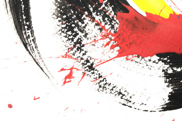 Vibrant thick red black and yellow acrylic paint splashes lines and swirls on a white background